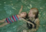 Child floating with instructor